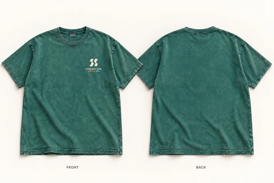 Front and back of a washed forest-green T-shirt with a small cream Homebot One logo on the left chest.